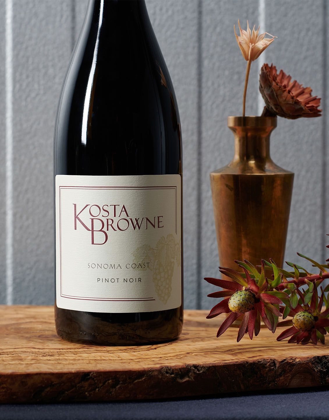 Kosta Browne Sonoma Coast Pinot Noir 2023 on an olive wood board
